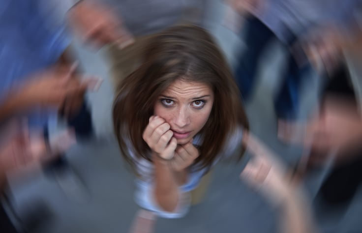 woman in a state of panic, surrounded by blurred images