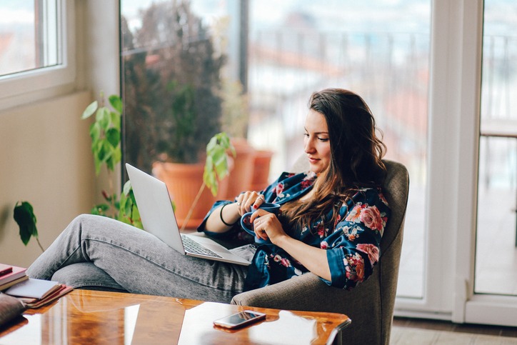 Young woman working at home at the laptop