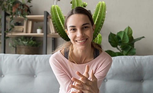 A house cactus behind a woman showcasing a poor video composition