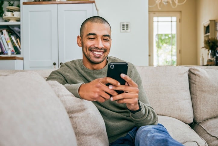 Man using his cell phone smiling