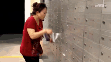 GIF image of a woman stuffing flyers in post office boxes