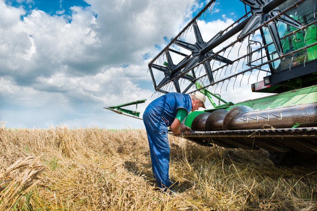 Frustrated farmer with broken equipment