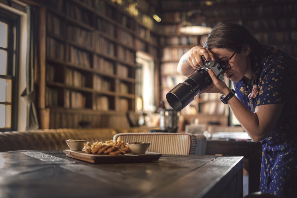 Food photography professional taking a shot of a plate of cookies.