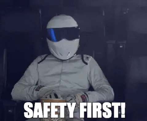 The Stig throwing popcorn at his face while wearing a hemlet with the caption"Safety First"
