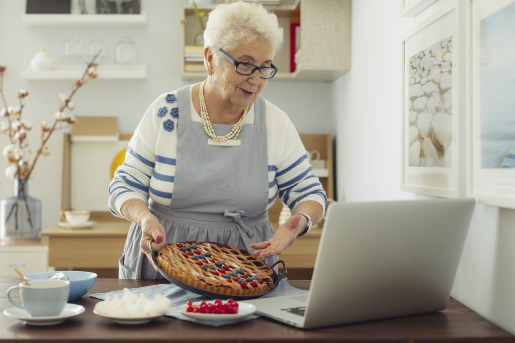 Senior woman taking an online baking class