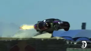 Car with an attached rocket flying through the air.