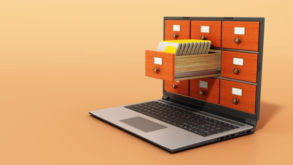 File cabinets or catalogue drawers inside the laptop screen with folders standing inside the drawer