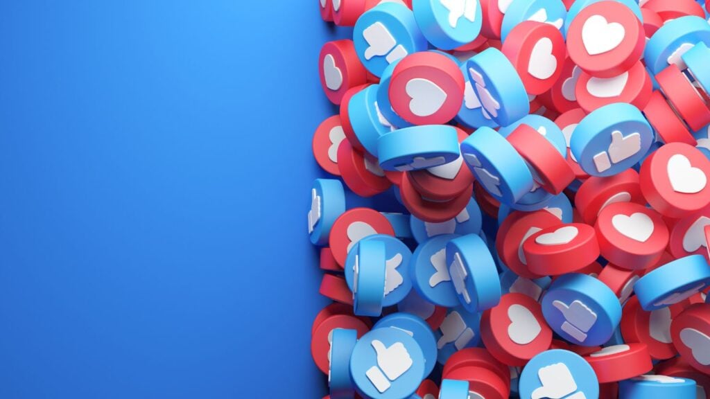 A 3D render of a pile of hearts and thumbs up icons.