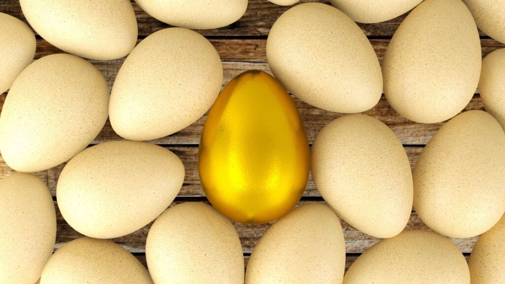 A golden egg in the middle of regular eggs.