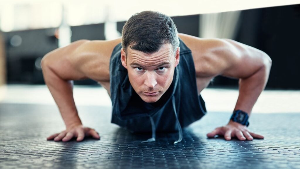 Man doing a push up rep and looking determined