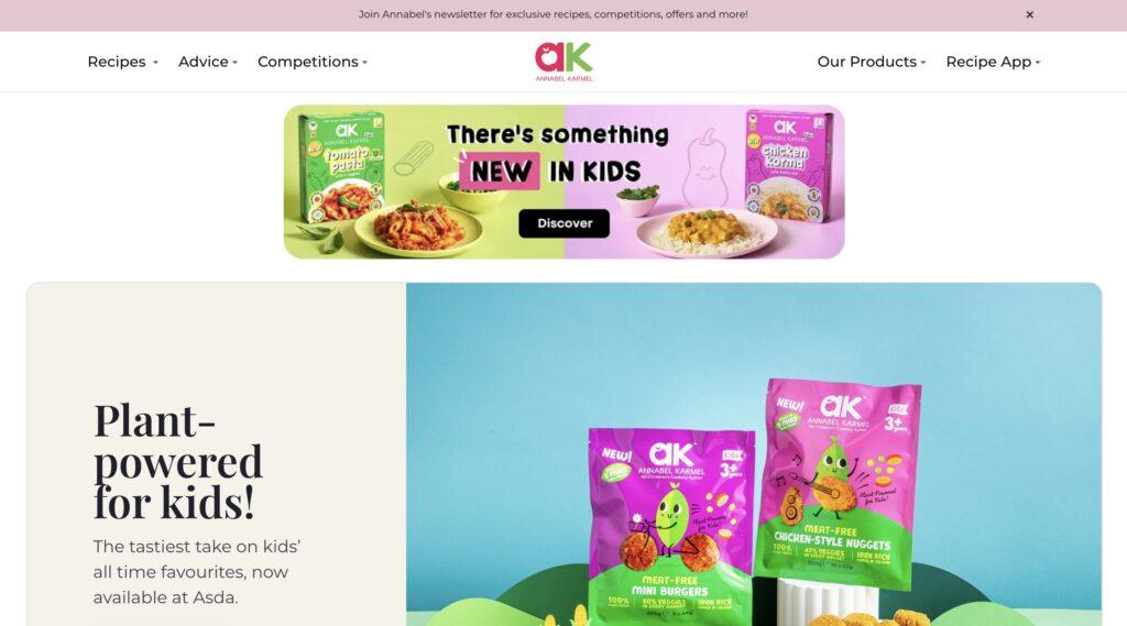 Annabel Karmel | MemberPress Hero banner promoting plant-powered kids' meals from Annabel Karmel with colorful product packaging on left and right