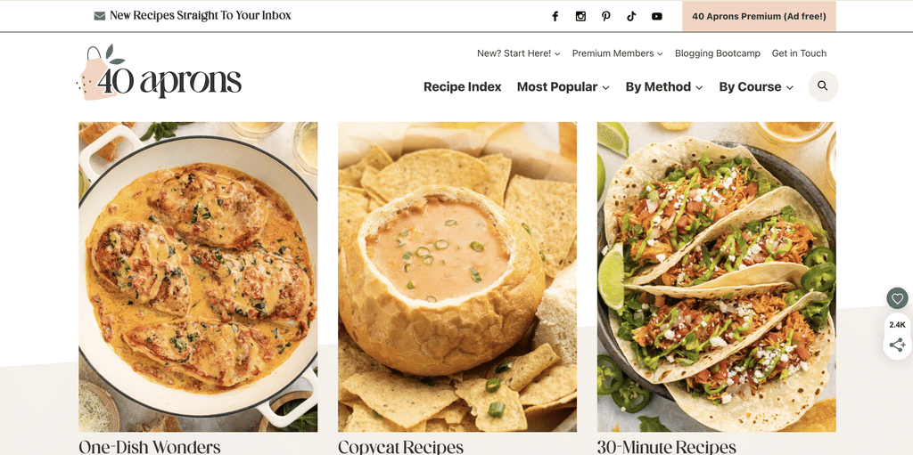 40 Aprons homepage screenshot 2026 | MemberPress Three recipe photos in a grid: a creamy chicken dish in a skillet, a bread-bowl soup, and colorful tacos with lime and toppings.