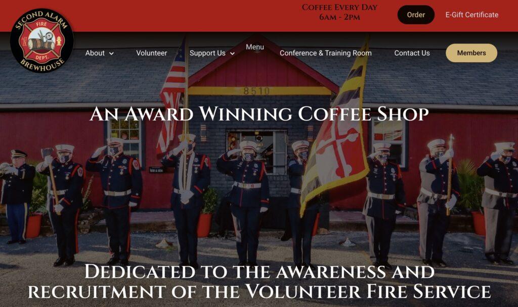 Second Alarm Brewhouse Homepage Screenshot | MemberPress Line of uniformed firefighters with flags in formation during a ceremony outdoors in front of a red building.